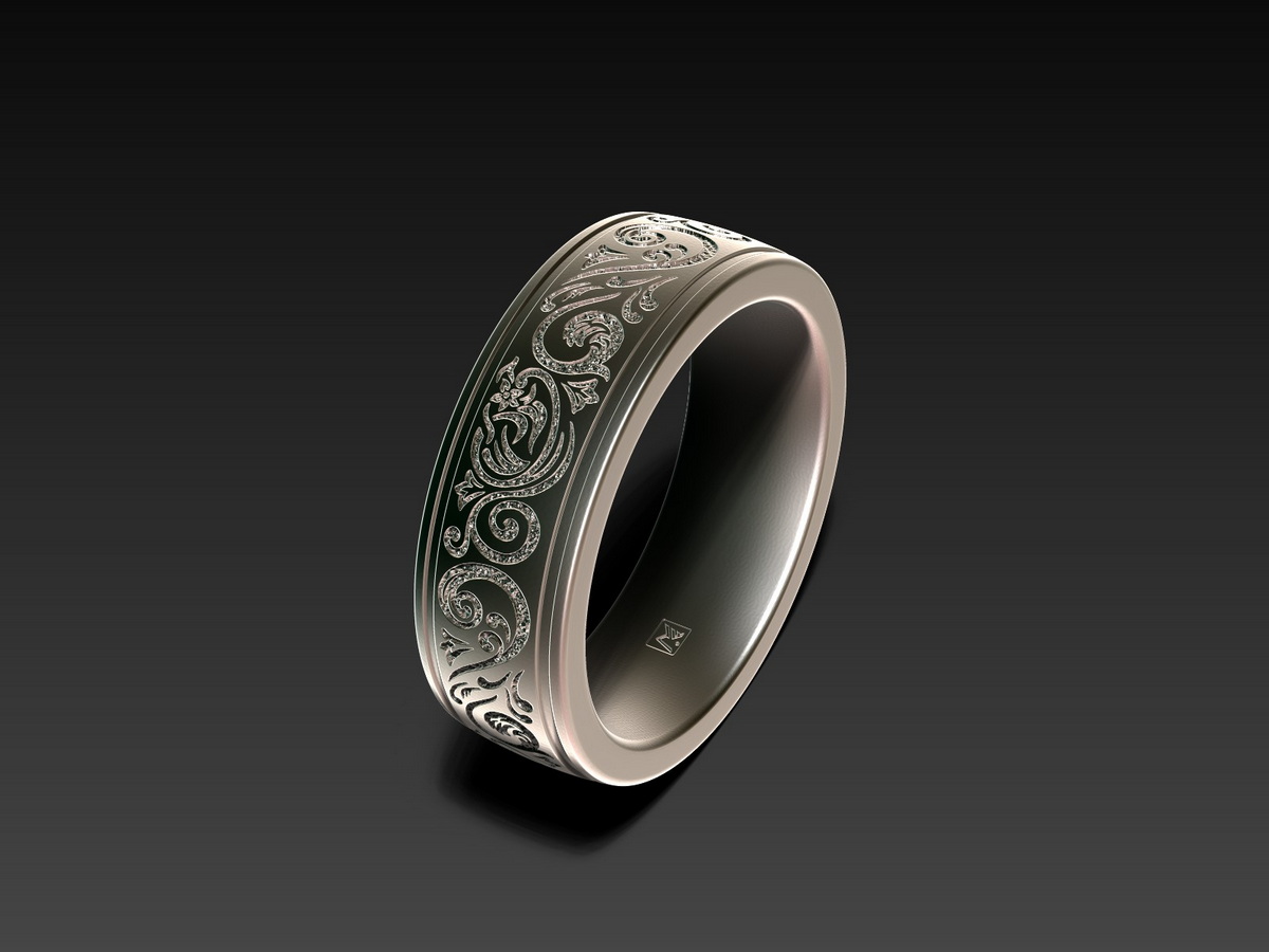Ornamental ring with a deeply engraved ornamental pattern set into the smooth surface of the band, creating strong contrast and visual depth.